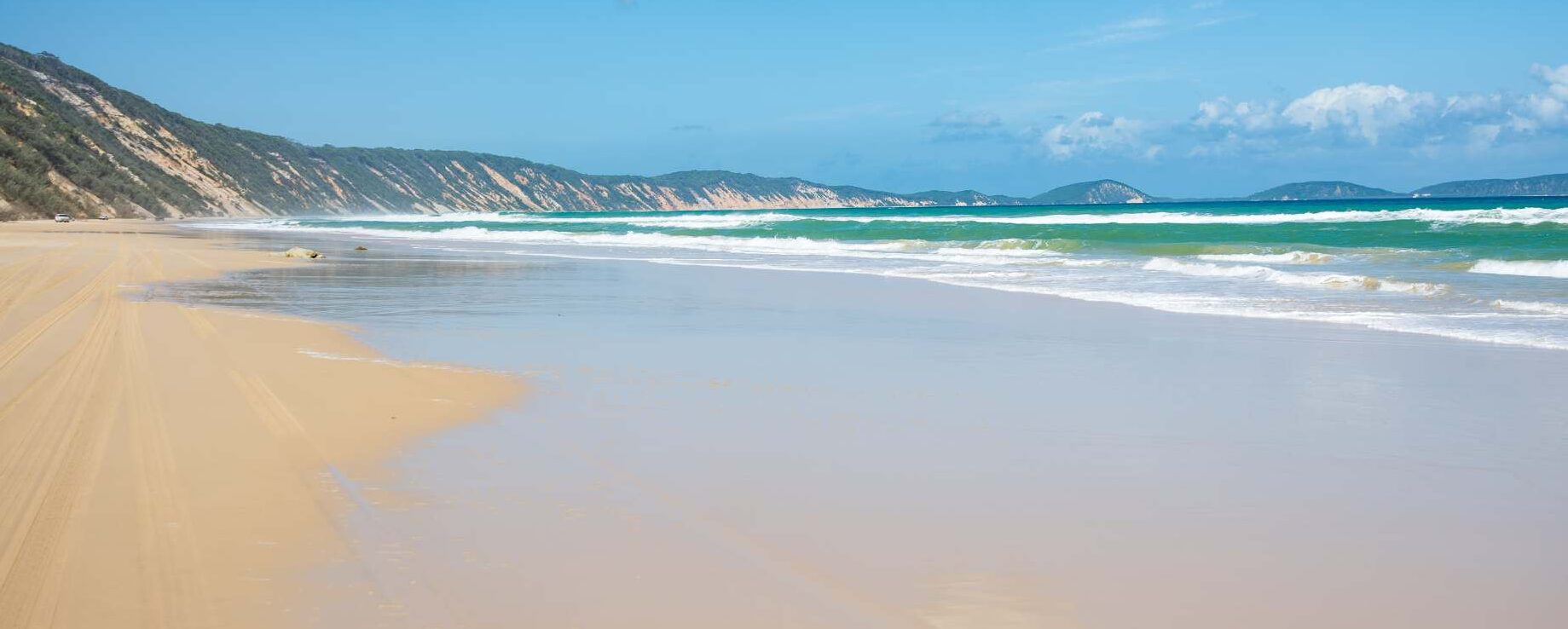 waves rolling up onto the sandy Fraser Island Beach