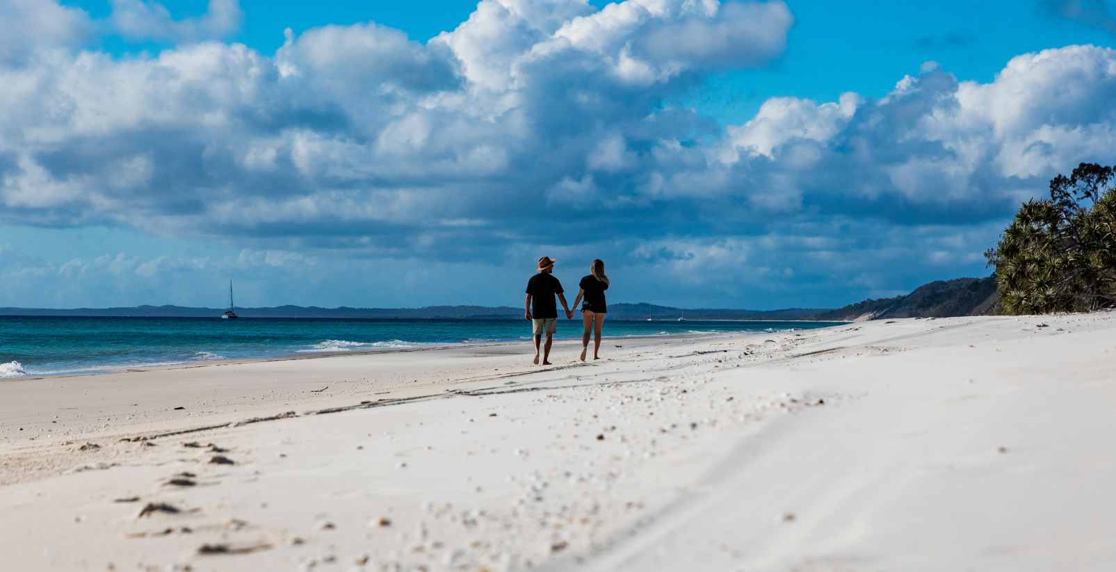 Two People walking along beach