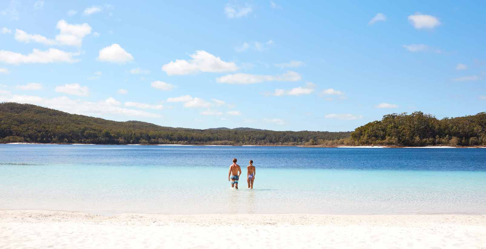 Two People walking along lake